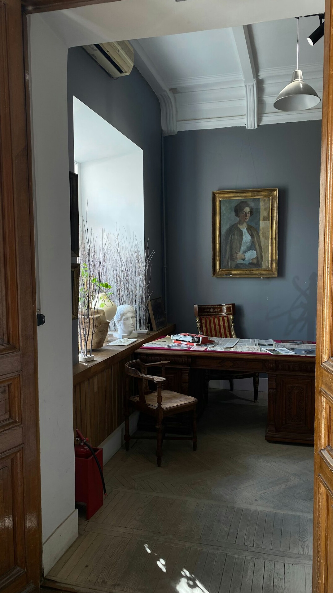 Editorial office with bookshelves and a wooden writing desk