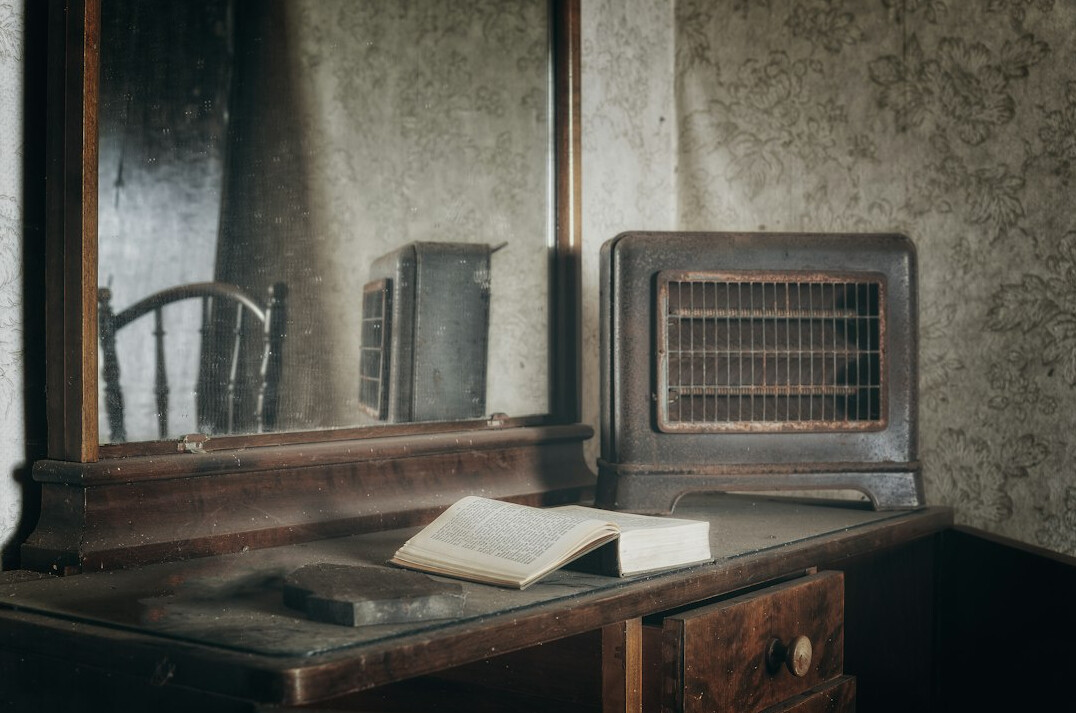 Detective desk with open notebook, magnifying glass and vintage typewriter
